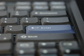 computer keyboard with enter key in blue