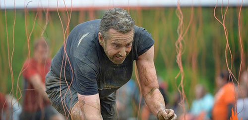 man competing in tough mudder