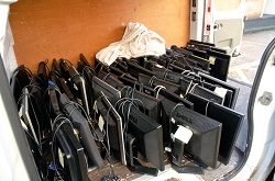 A pile of computer monitors ready for donation