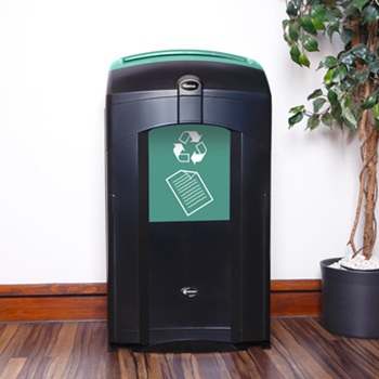 nexus 100 paper recycling against a white wall next to a potted tree